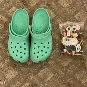 teal crocs with gibbets